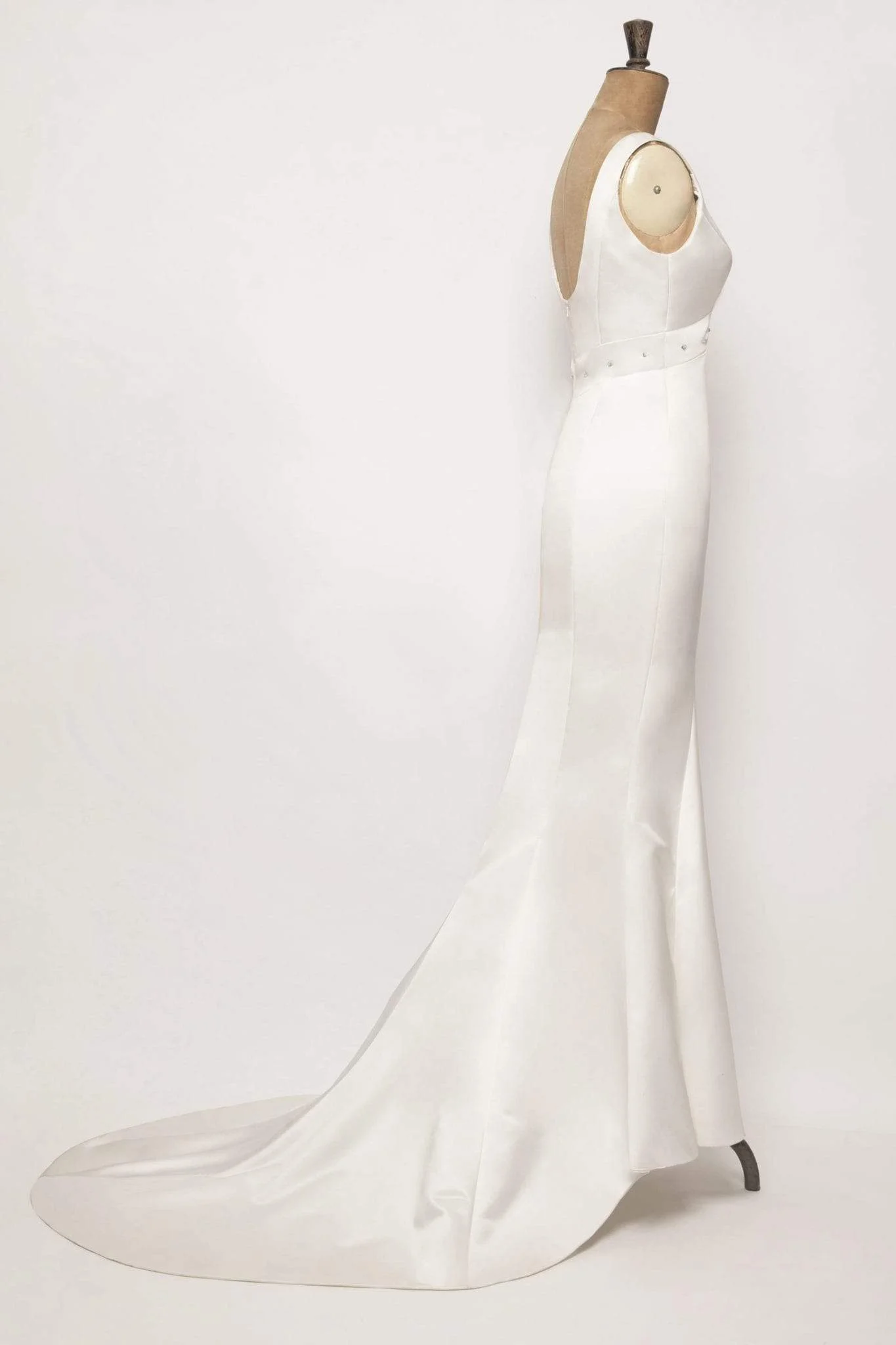 Elegant mermaid wedding gown in duchess satin, empire waist, diamond detail below bust, and a simple yet stunning fishtail train.