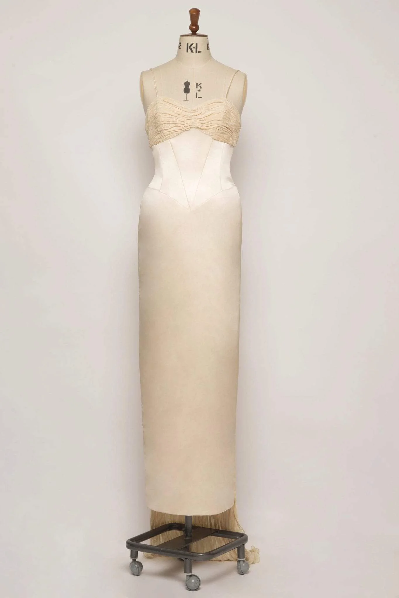 Sweetheart neckline wedding dress in champagne duchess satin with shoestring straps, crushed silk bust detail, and detachable train