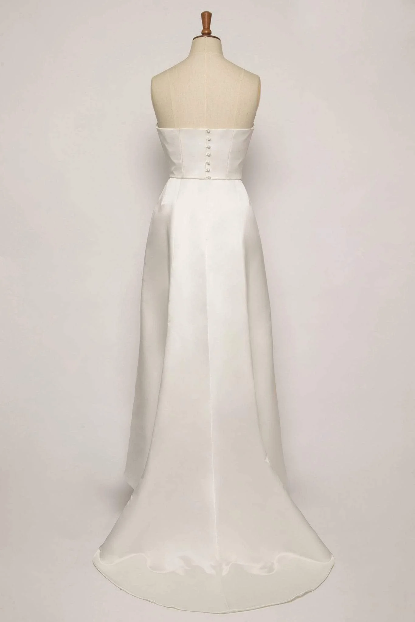 Elegant two-piece bridal dress with strapless bodice, A-line skirt, chapel train, and two handcrafted satin flower accents.