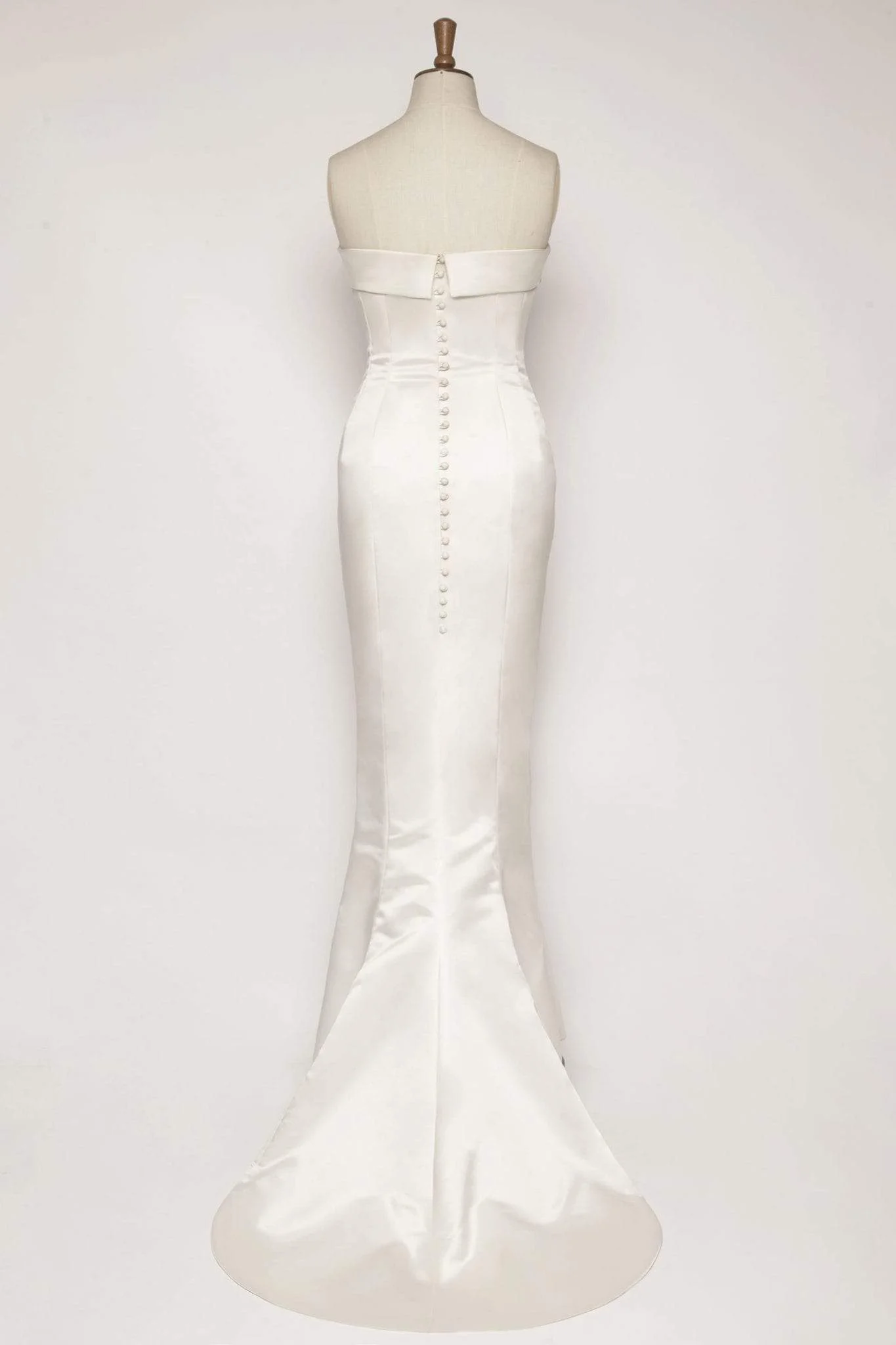 Duchess satin mermaid wedding dress with cuff detail at the neckline and train, finished with working covered buttons for a sleek and elegant bridal look