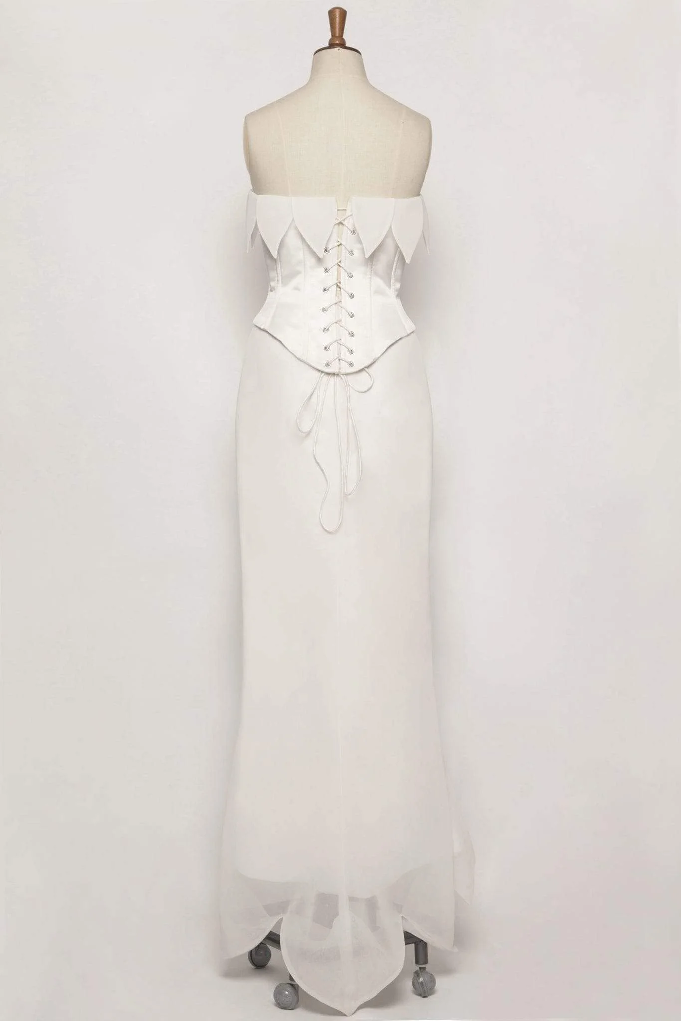 U-shape boned corset in duchess satin with lace-up fastening, paired with a chiffon mermaid skirt featuring leaf styling and a leaf-shaped train.