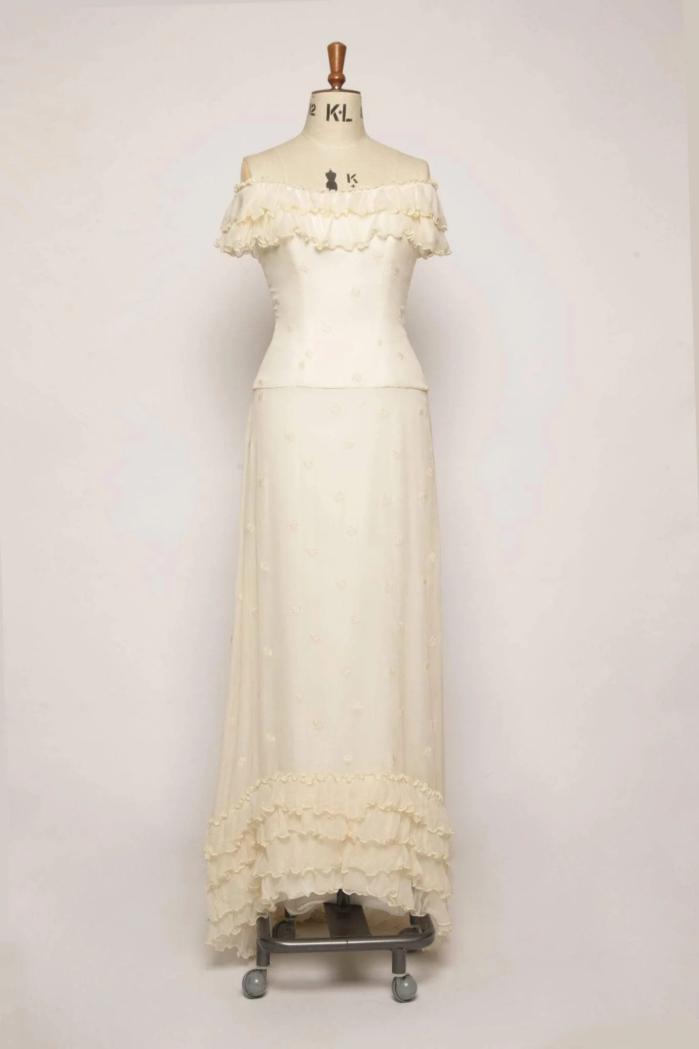 Cotton Rosemallow silk chiffon ruffle wedding dress front view on mannequin showing off shoulder bodice and layered ruffle detail
