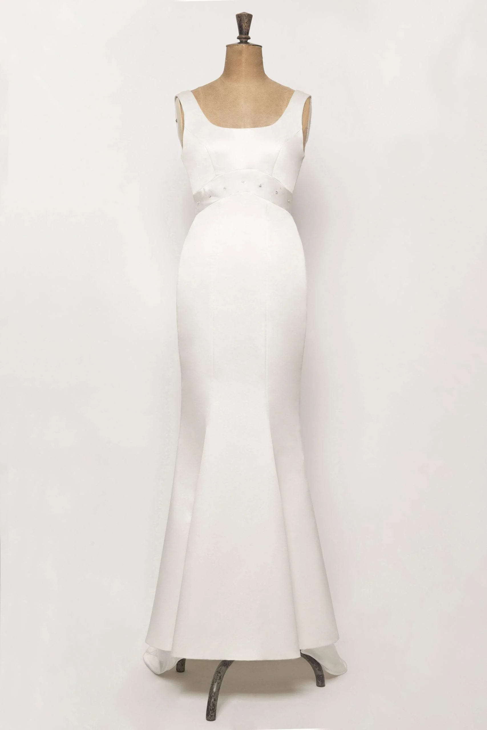 Elegant mermaid wedding gown in duchess satin, empire waist, diamond detail below bust, and a simple yet stunning fishtail train.