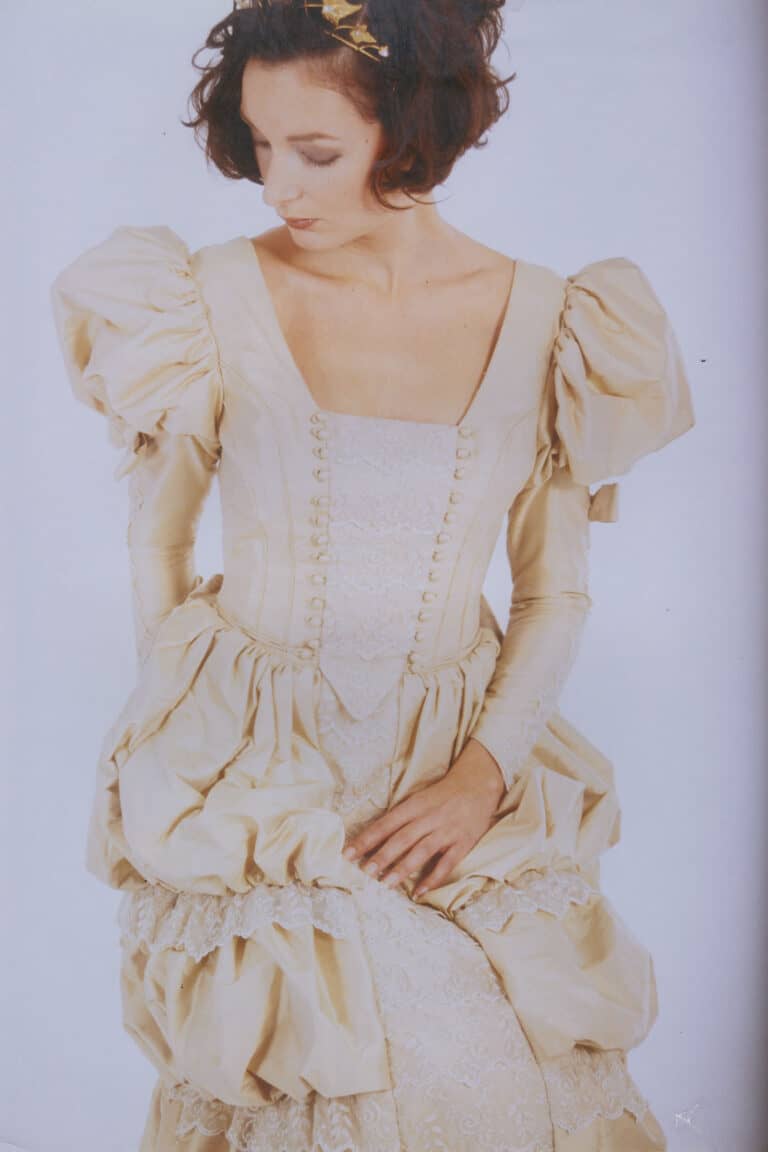 Queen Victoria Victorian couture wedding dress front close up on model seated showing boned corset lace and silk button detail
