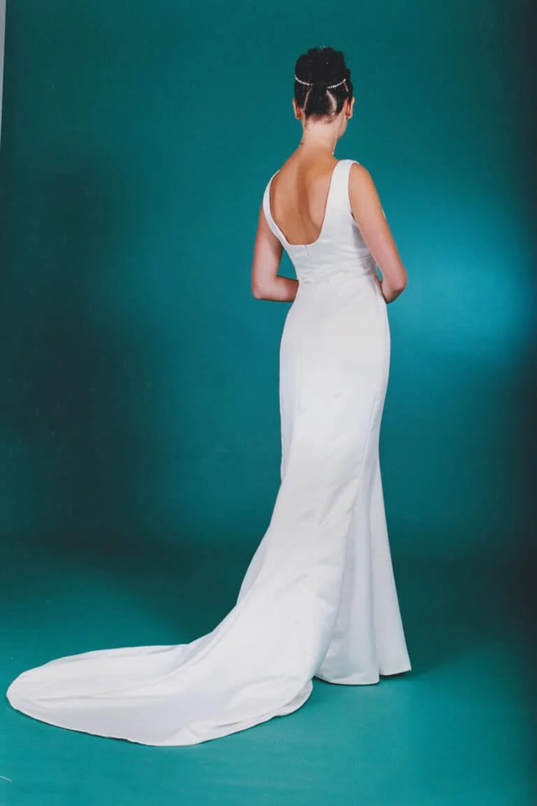 Elegant mermaid wedding gown in duchess satin, empire waist, diamond detail below bust, and a simple yet stunning fishtail train.