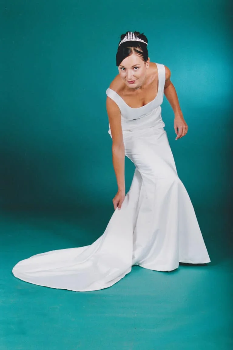 Elegant mermaid wedding gown in duchess satin, empire waist, diamond detail below bust, and a simple yet stunning fishtail train.